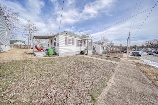 view of front of home featuring fence