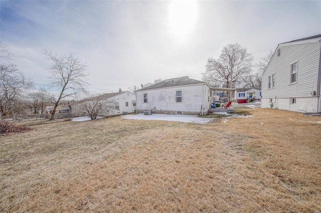 back of property featuring a lawn and a residential view