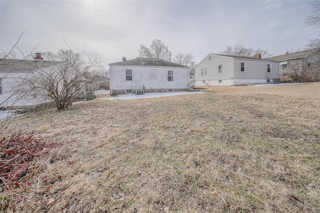 back of property with a yard, central AC unit, and a patio area