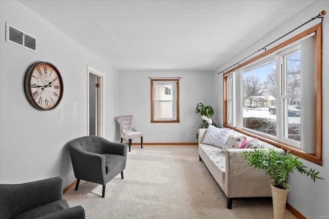 living room featuring light carpet, baseboards, and visible vents