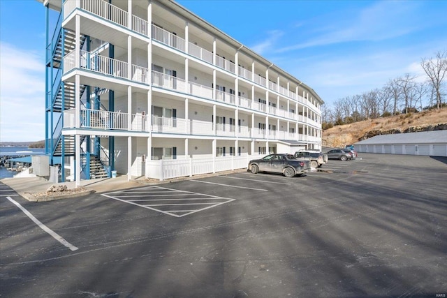 view of building exterior with uncovered parking