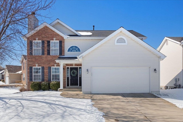 view of front facade with a garage, concrete driveway, and brick siding