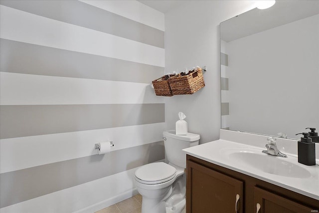 half bath with tile patterned flooring, vanity, and toilet