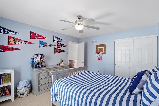 bedroom with light colored carpet, a closet, visible vents, and ceiling fan