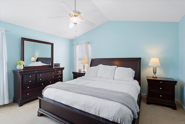 bedroom featuring a ceiling fan, light colored carpet, vaulted ceiling, and baseboards