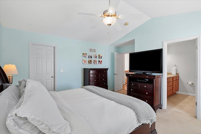 bedroom with visible vents, a ceiling fan, light carpet, connected bathroom, and vaulted ceiling