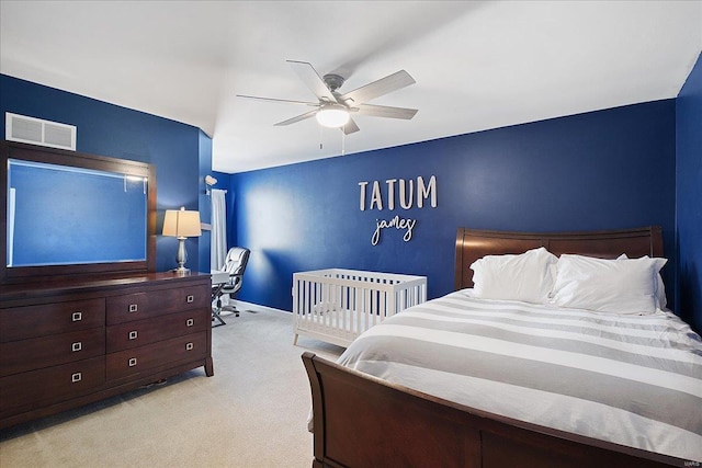 bedroom with light colored carpet, visible vents, ceiling fan, and baseboards