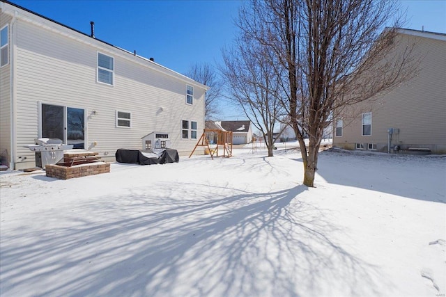 view of snow covered back of property