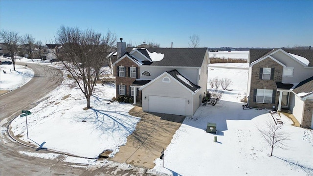 snowy aerial view with a residential view