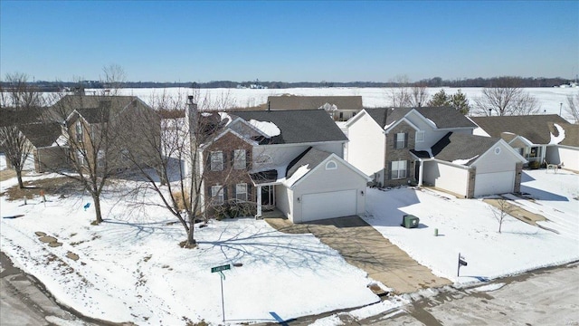 snowy aerial view featuring a residential view