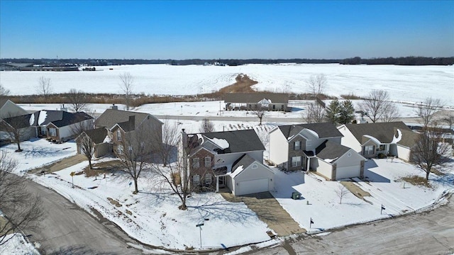 snowy aerial view featuring a residential view