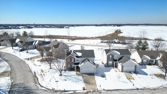 snowy aerial view featuring a residential view