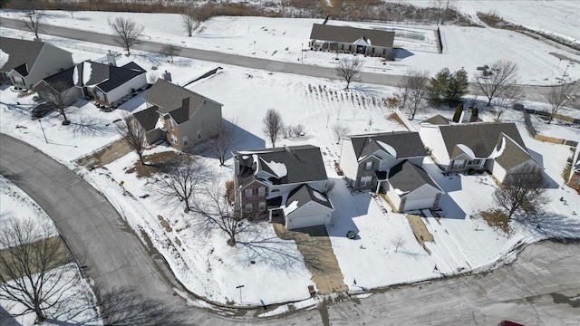 snowy aerial view with a residential view