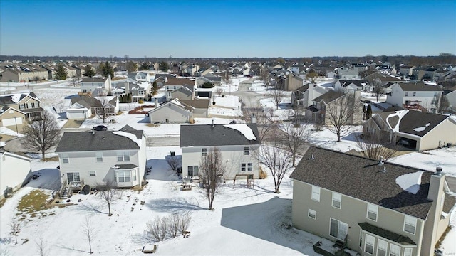 snowy aerial view featuring a residential view