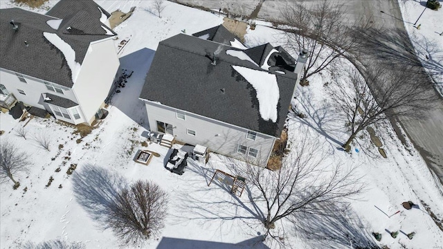 snowy aerial view with a residential view