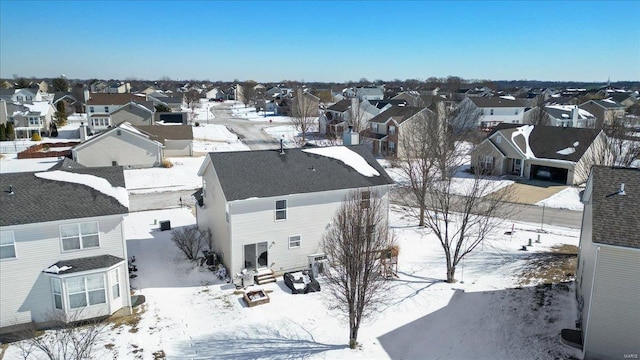 snowy aerial view featuring a residential view