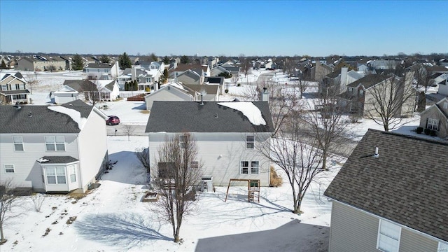 snowy aerial view with a residential view