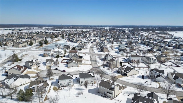 snowy aerial view with a residential view