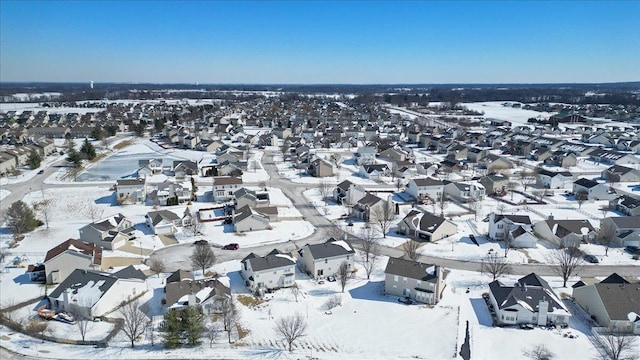 snowy aerial view featuring a residential view