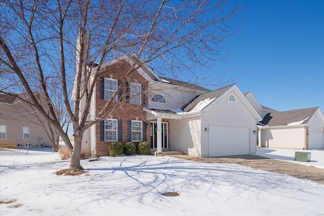 view of front of property with driveway, brick siding, and an attached garage