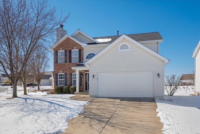 traditional-style home featuring a garage, concrete driveway, brick siding, and a chimney