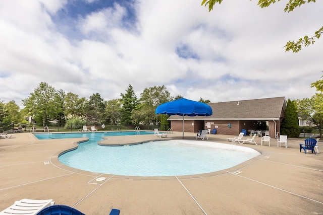 community pool featuring a patio and fence