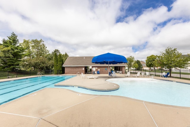 pool with fence and a patio