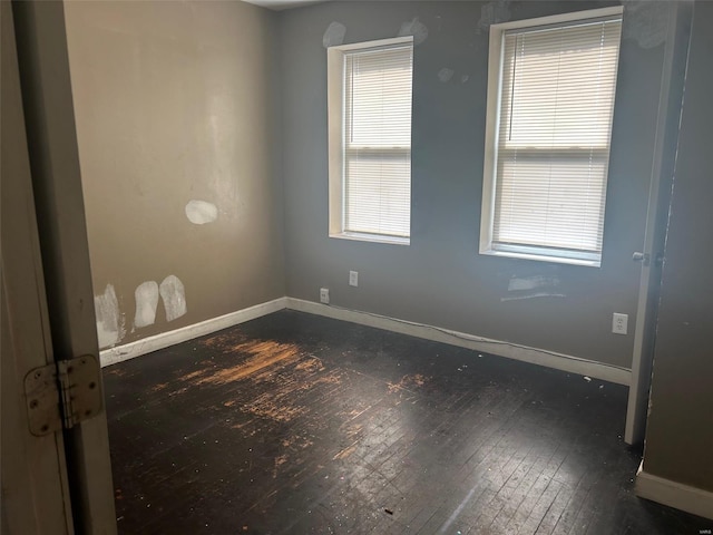 empty room with dark hardwood / wood-style floors