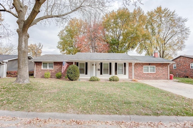 ranch-style house featuring a chimney, a front lawn, and brick siding