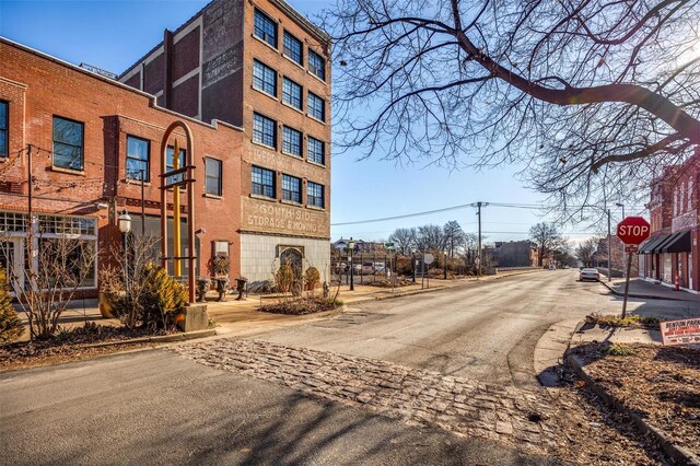 exterior space with traffic signs, curbs, and sidewalks