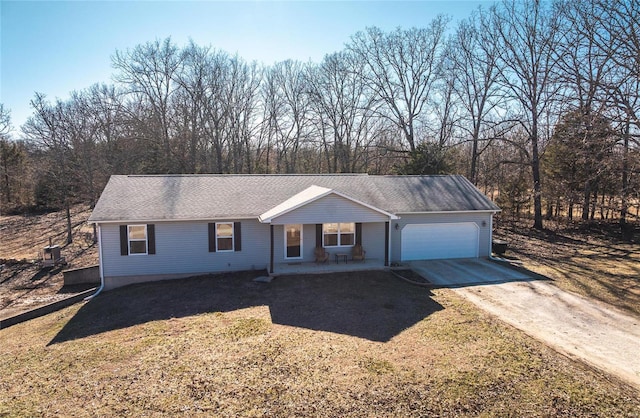 ranch-style house featuring concrete driveway, roof with shingles, and an attached garage