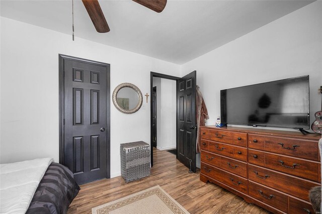 bedroom with a ceiling fan and light wood-type flooring