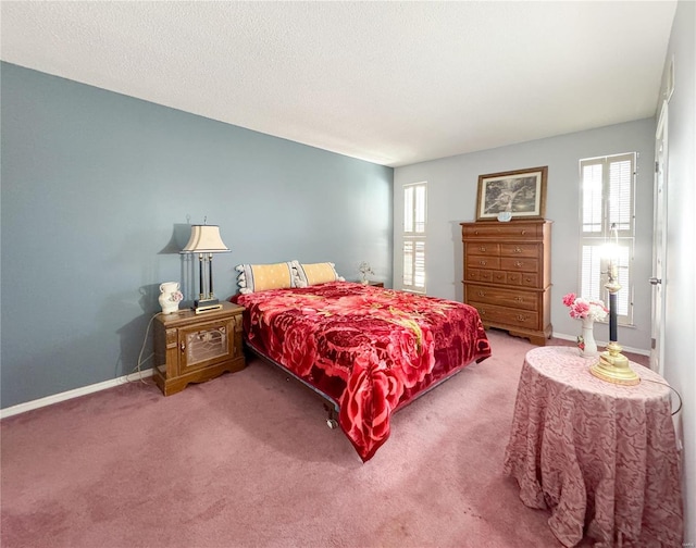 bedroom with carpet flooring, baseboards, and multiple windows