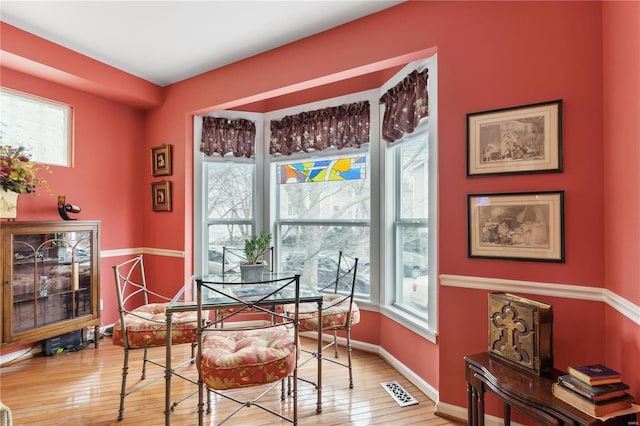 dining room with hardwood / wood-style flooring and plenty of natural light