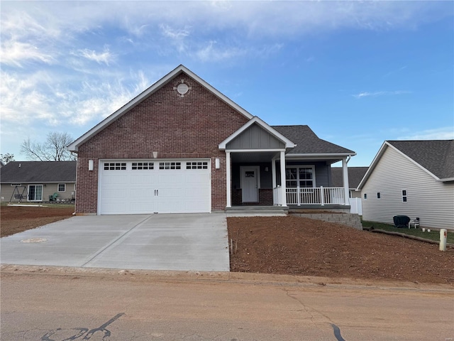 view of front of home featuring driveway, roof with shingles, a porch, an attached garage, and brick siding