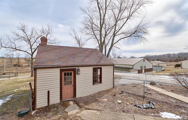 view of outbuilding featuring fence