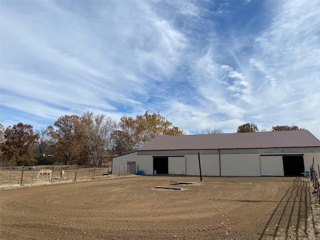 view of pole building featuring fence