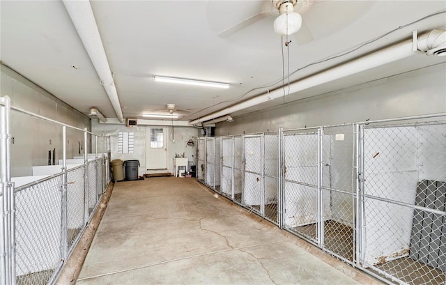 storage area with ceiling fan and a sink