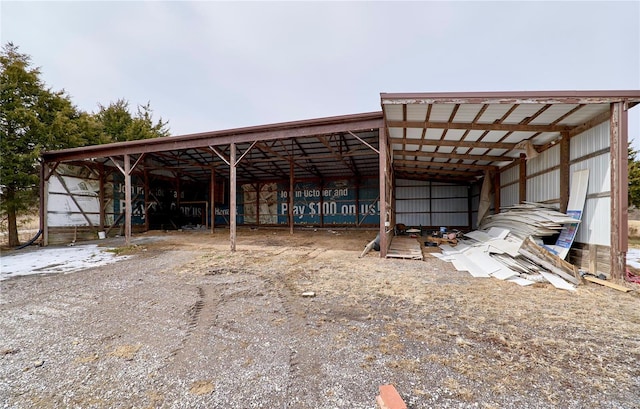 view of vehicle parking featuring an outbuilding