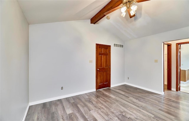 empty room featuring baseboards, lofted ceiling with beams, visible vents, and light wood-style floors