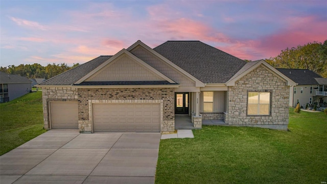 craftsman inspired home with a garage, a shingled roof, concrete driveway, and a yard