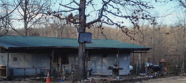 back of property featuring metal roof