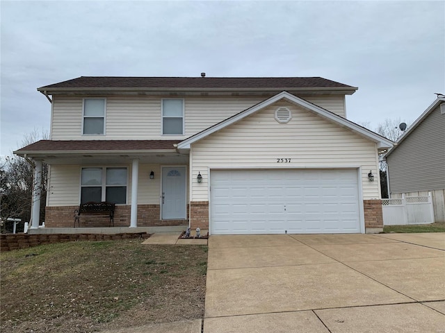 traditional home with brick siding, covered porch, an attached garage, and concrete driveway