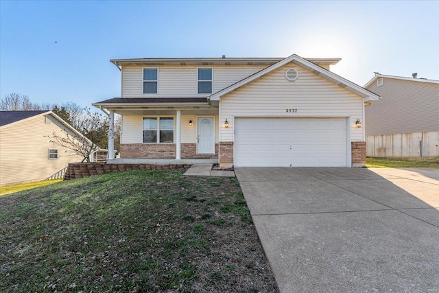 traditional-style home with brick siding, concrete driveway, a front yard, covered porch, and a garage