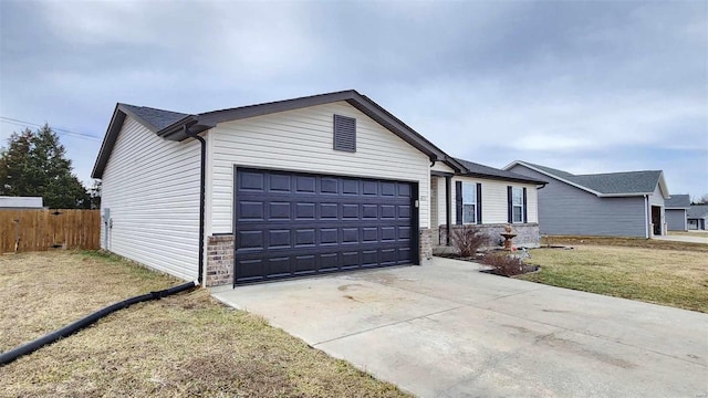 single story home featuring an attached garage, fence, a front lawn, and concrete driveway