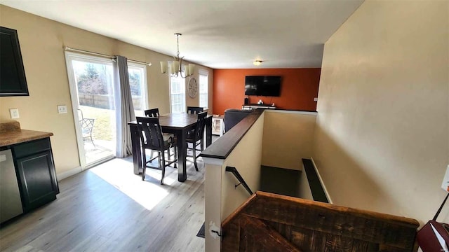 dining area with light wood finished floors and baseboards