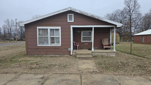 bungalow-style house with a front yard