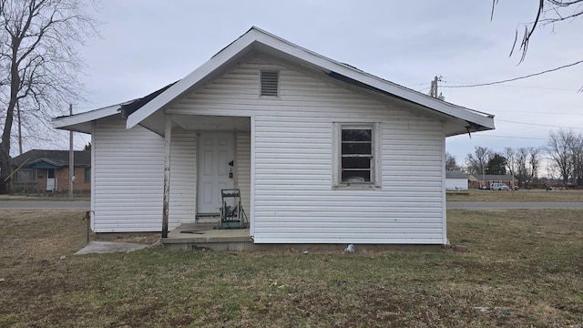 rear view of house with a lawn