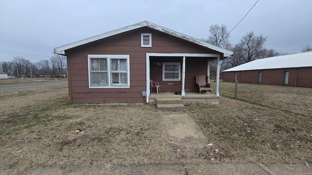 bungalow-style home featuring a front yard and a porch