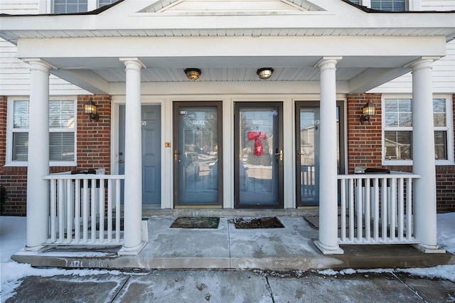 property entrance featuring brick siding